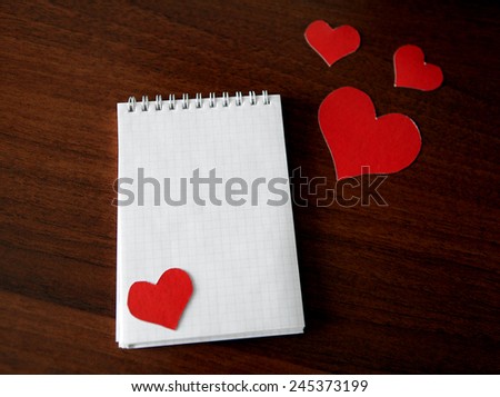 Blank Writing Pad with Heart Shapes on The Table