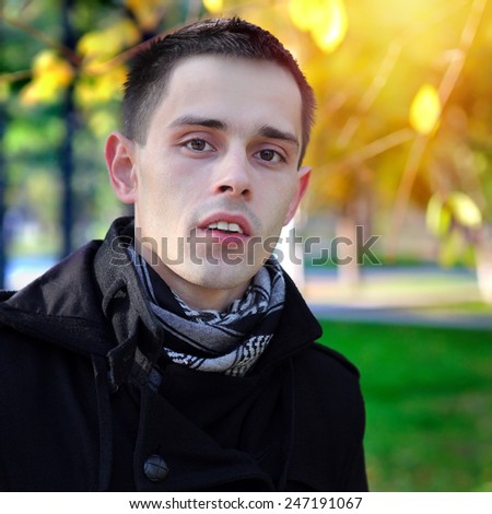 Portrait of the Young Man at the Autumn Park