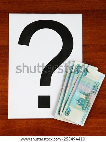 Russian Currency and Question Mark on the Wooden Background