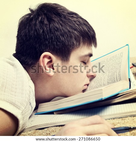 Toned Photo of Tired Teenager sleep on the Book