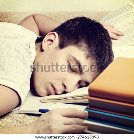 Toned Photo of Tired Teenager sleep on the Book
