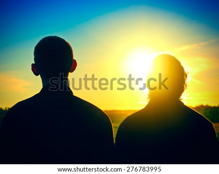 Vignetting Photo of Two Persons Silhouette on Sunset Background