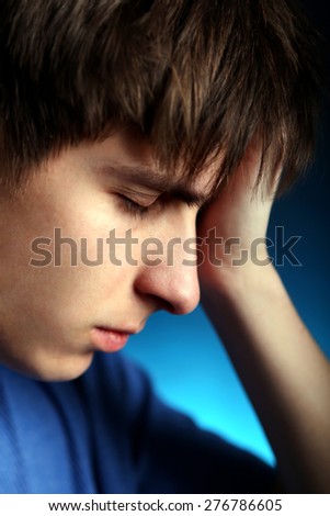 Sad Young Man in the Dark Room closeup