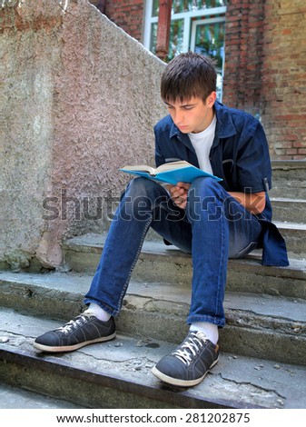 Teenager read the Book on the Landing Steps of the Old House