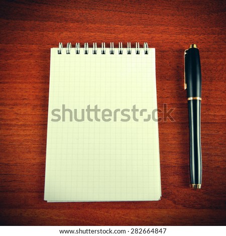 Toned Photo of Blank Writing Pad and Pen on The Table