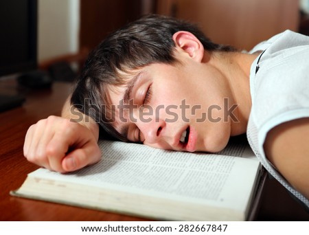 Young Man sleep on the Book at the Home