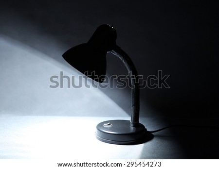 Desk Lamp on Table in the Dark Room