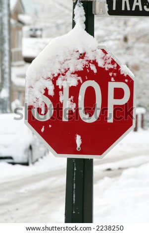 heavy snow and stop sign, concept of bad weather