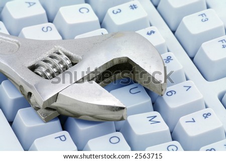 Adjustable Wrench and keyboard, concept of computer repairing