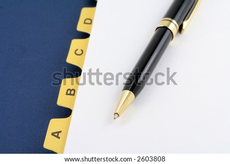 yellow file divider and pen, office supplies, close up