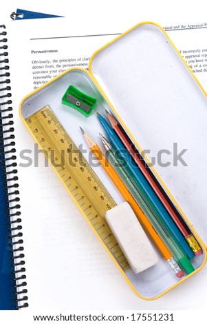 Metal pencil case and book with white background