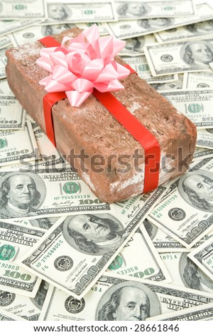 Red Brick Gift and dollars, Concept of joke, make fun of somebody, gift on April Fool\'s Day, Prank gift