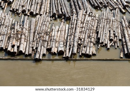 Log and Lumber Floating On Water