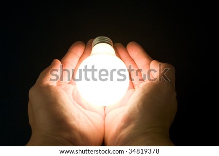 Hand and a Bright Light Bulb, Concept of Inspiration, Ideas