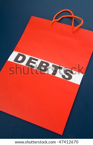 Shopping Bag and word debts concept of Financial difficulty