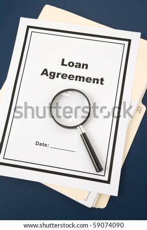 Loan Agreement and Magnifying Glass, business concept