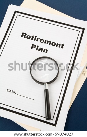 Retirement Plan and Magnifying Glass, business concept