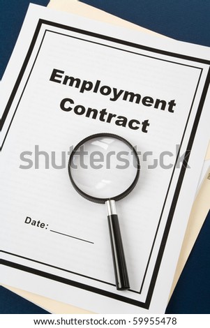 Employment Contract and magnifier, business concept