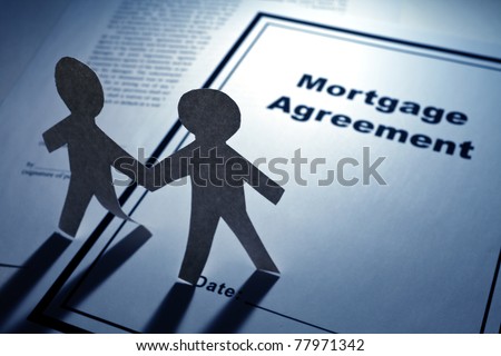 Mortgage Agreement and Paper Chain Men close up