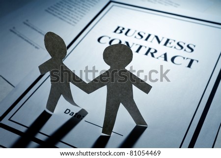 Business Contract and Paper Chain Men close up