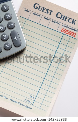 Guest Check and calculator, concept of restaurant expense. Fake Guest Check,