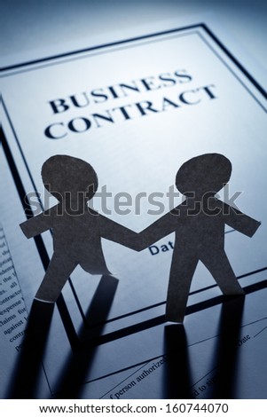 Business Contract and Paper Chain Men close up