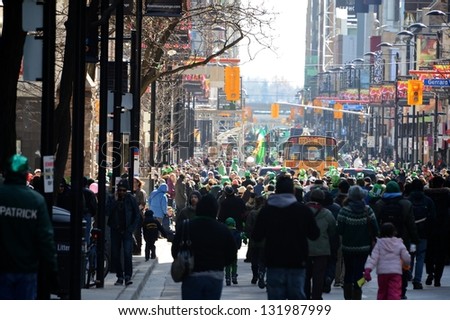 TORONTO - MARCH 17: Huge crowd takes over the street. Toronto's annual St. Patrick's Day parade takes place under sunny skies on Sunday afternoon March 17, 2013 in Toronto.