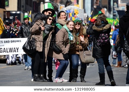 TORONTO - MARCH 17: People take photos at the parade. Toronto\'s annual St. Patrick\'s Day parade takes place under sunny skies on Sunday afternoon March 17, 2013 in Toronto.