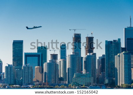 Plane flys over the city(Building signs are removed)