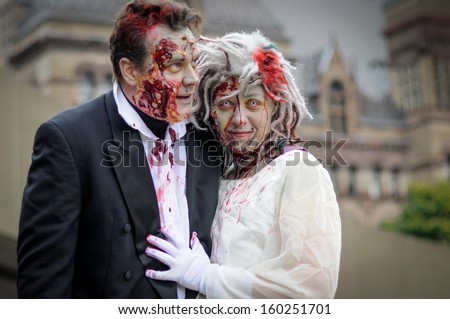 TORONTO - OCTOBER 26: People take part in the 11th Zombie Walk Parade in Toronto, Canada on October 26, 2013.