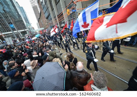 TORONTO - NOVEMBER 11: Military parade takes place during Remembrance Day Services at Old City Hall Cenotaph in Toronto on November 11, 2013.