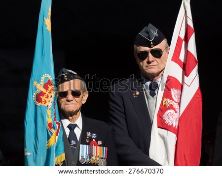 TORONTO, CANADA - NOVEMBER 11, 2014: Two veterans stand still at the annual Remembrance Day service held at the Old City Hall Cenotaph.