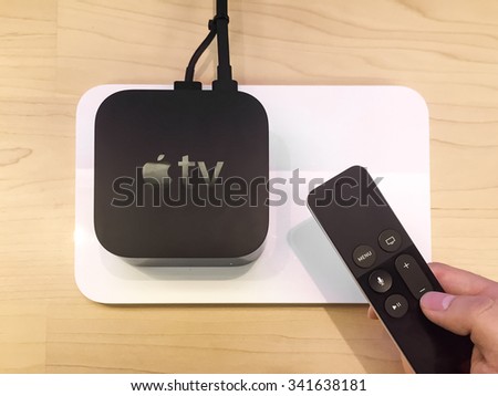 TORONTO, CANADA - NOVEMBER 20, 2015:  Customer hands on the new Apple TV at the Apple Store.
