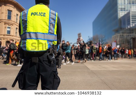 Police standing by to protect teens peacefully marching  in protest