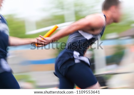 Motion blurred relay race at a track and field event