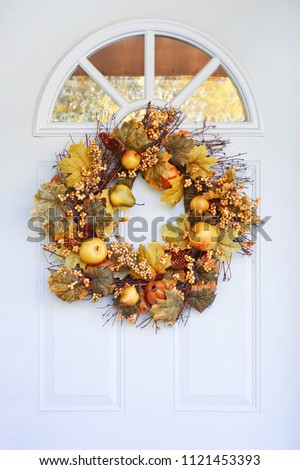 Autumn wreath hanging on a front door,