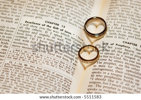 stock photo Two wedding rings on a bible open to Corinthians Chapter 13