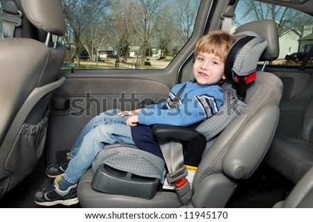 Preschool age boy in a booster seat