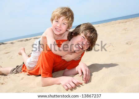 Brothers playing on the beach