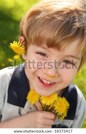 Boy playing with Dandelions