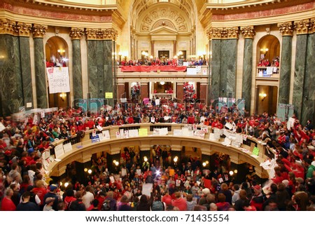 MADISON, WI - FEB 17: Thousands fill the capitol protesting Wisconsin Gov Scott Walker\'s proposal to eliminate collective bargaining rights for public workers on Feb 17, 2011 in Madison Wisconsin.