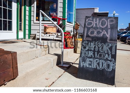 Shop local saturday, support your local weirdos, humorous sign written in chalk, supporting small local businesses