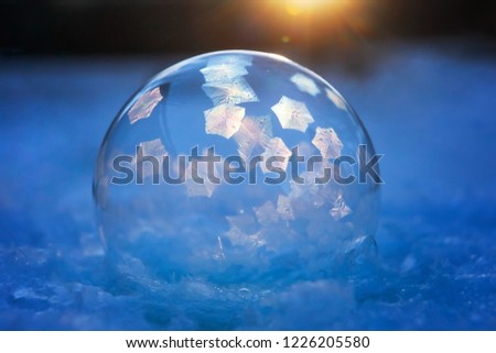 First image in a science experiment series of frozen bubble with ice crystals,  ice crystals just starting to form