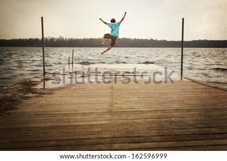 Teen Boy Jumping off a dock