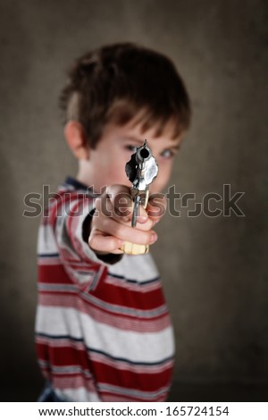 Boy aiming toy gun, shallow focus