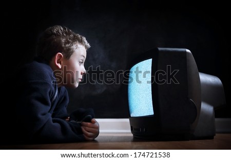 Boy watching television with noise