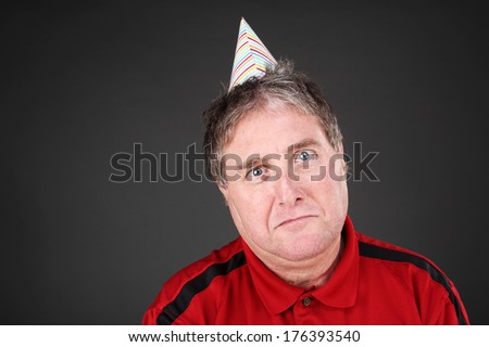 Sad man wearing a party hat