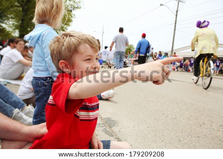 Boy watching a parade,