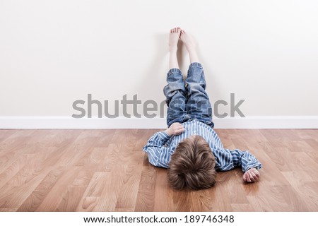 Young boy laying on the floor