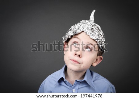Boy in a tin foil hat looking up